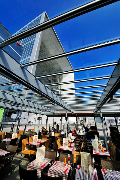Dining area in Paris with modern building under clear sky Digital Download