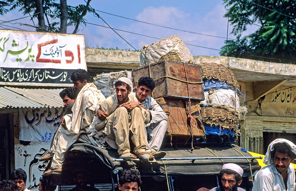 Men travel on top of a vehicle in Peshawar Pakistan Digital Download