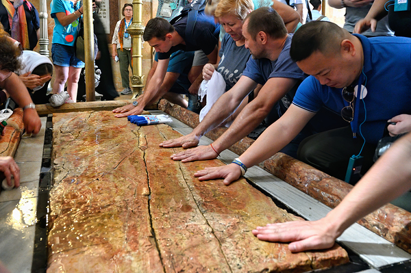 Visitors touch the stone of unction in the Holy Sepulchre Digital Download