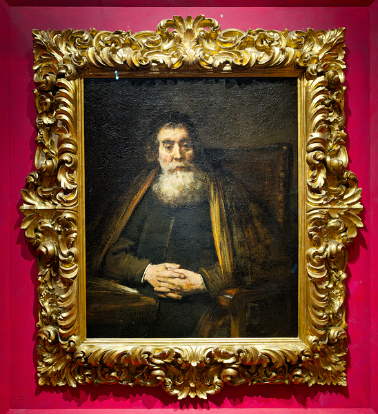 A rabbi sits calmly in a chair with hands together Digital Download