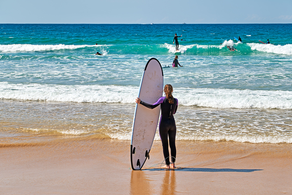Surfer girl with surfboard on beach watching waves Digital Download