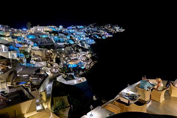 Illuminated cliffside town at night couple enjoying dinner. Digital Download