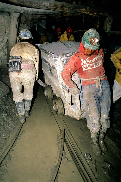 Miners pushing a loaded cart through a muddy underground mine. Digital Download