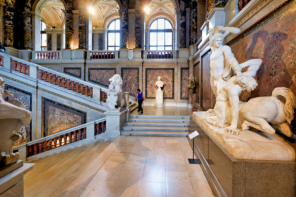 Ornate museum hall with statues grand staircase and visitor. Digital Download