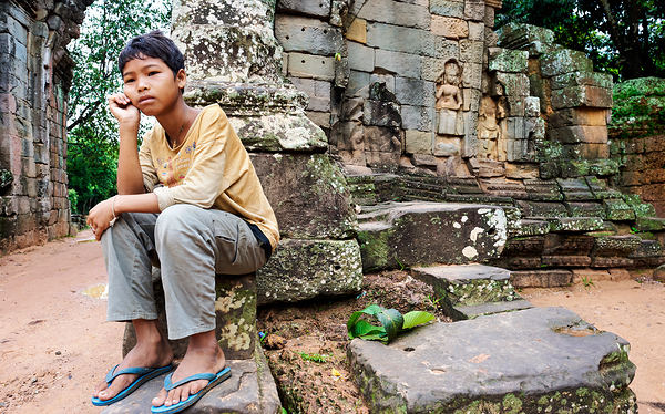 Young person sits on ancient temple ruins. Digital Download