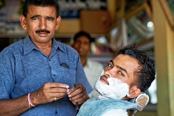 Barber at work in Khimsar Rajasthan India during a busy day Digital Download