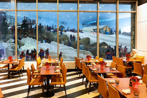 Restaurant offers view of snow activities at indoor park in Duba Digital Download