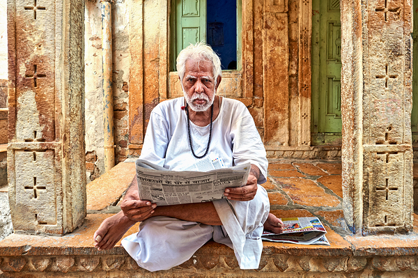 Man reads newspaper on street in Jaisalmer Rajasthan India Digital Download