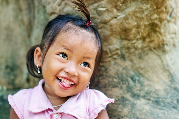 Joyful young girl with a playful smile and tongue out. Digital Download