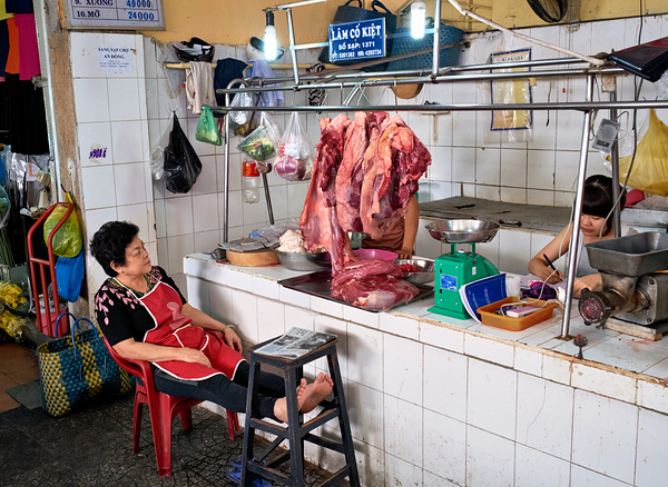 Market scene in Ho Chi Minh City with meat vendor and customer Digital Download