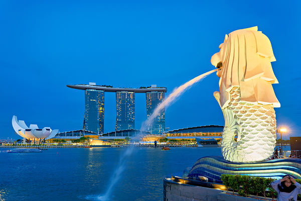 Visitors watch the Merlion fountain at Marina Bay during sunset Digital Download