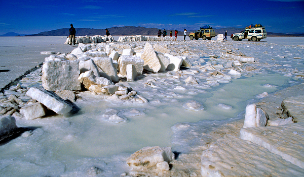Explorers on a salt flat with salt blocks and water. Digital Download