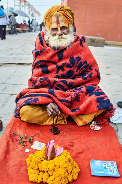 Holy man sadhu sits with offerings in Varanasi Uttar Pradesh Digital Download