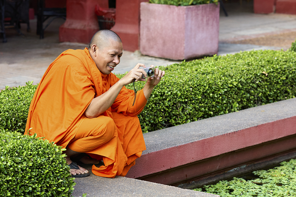 A buddhist monk taking a picture at the National Museum of Cambodia in Phnom Penh Digital Download