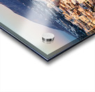 Santorini cliffside town at sunset with mountain backdrop. Acrylic print