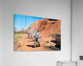 Tourists ride Segways near Uluru in Australia. Acrylic Print