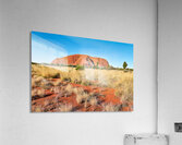 Uluru Australias iconic sandstone monolith under a clear blue Acrylic Print