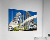 Woman walks on stairs in modern urban area with tall buildings Acrylic Print