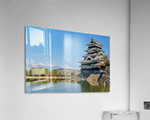 Matsumoto Castle stands beside water with mountains in the dista Acrylic Print