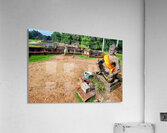 Ancient statue overlooks temple ruins amidst lush greenery. Acrylic Print