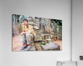 Young person sits on ancient temple ruins. Acrylic Print