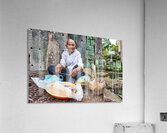 Elderly person selling goods at ancient temple ruins. Acrylic Print