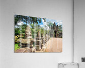 Ancient stone statues line path to Angkor Thom gate. Acrylic Print