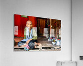 Elderly person sitting on floor in rustic dwelling. Acrylic Print