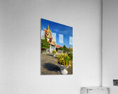 Golden temple green trees and birds under a blue sky. Acrylic Print