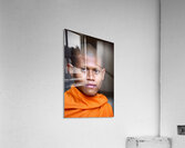 Young Buddhist monk in orange robe close up portrait. Acrylic Print
