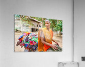 Monk with colorful textiles on a motorcycle. Acrylic Print