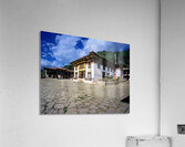Traditional Bhutanese building with stone courtyard under a clou Acrylic Print