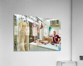 Butcher works in meat market in Dubai with hanging meat Acrylic Print