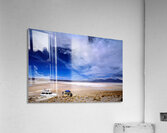 Vehicles traverse a vast arid salt flat landscape. Acrylic Print
