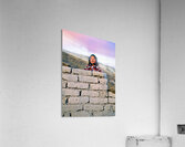 Young girl smiles over stone wall at sunset. Acrylic Print