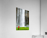 Woman walks near Seljalandsfoss waterfall in Iceland Acrylic Print