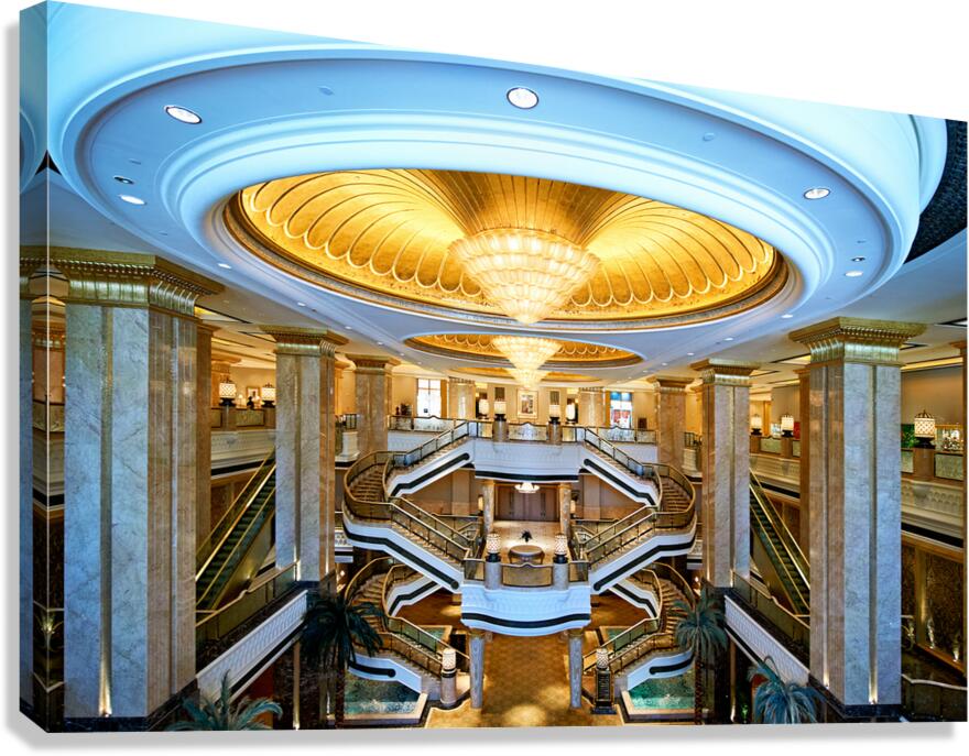 Opulent hotel lobby with grand staircases and golden dome.