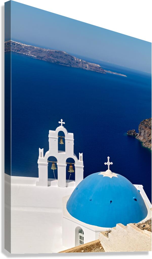 Blue domed church and bell tower overlooking Santorinis caldera