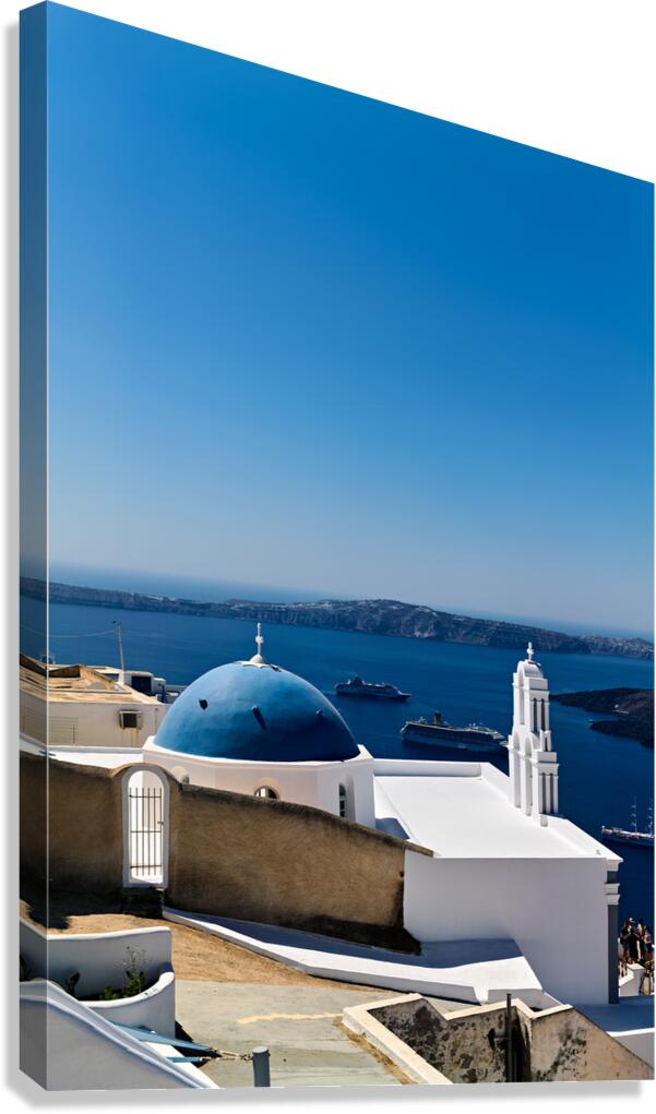 Santorinis blue domed church and bell tower overlooking the Aeg