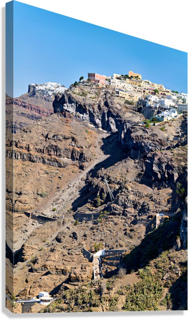 Santorini cliffside town with cable car and winding paths.