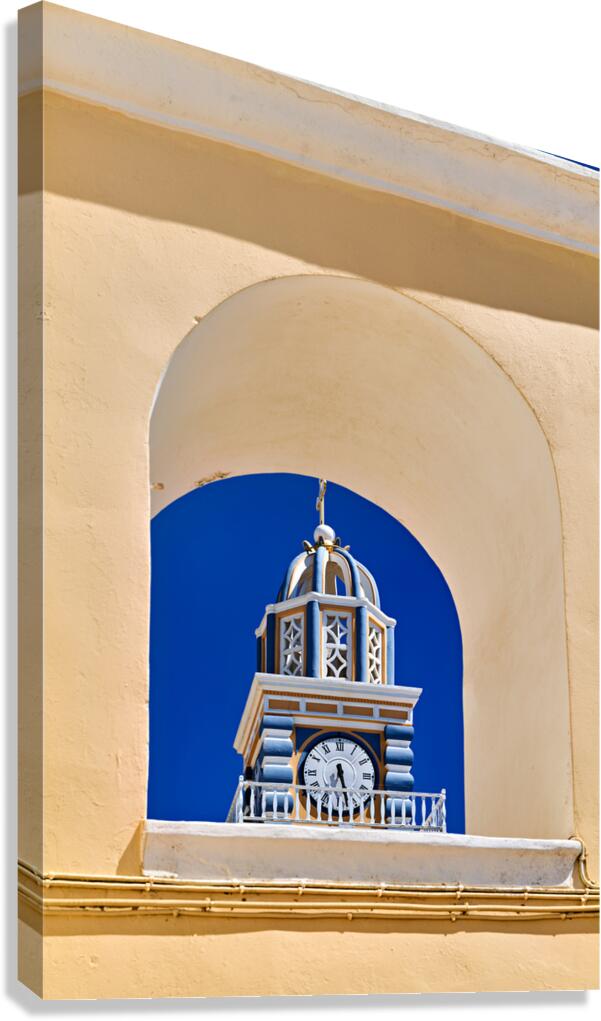Santorini clock tower framed by arch against blue sky.