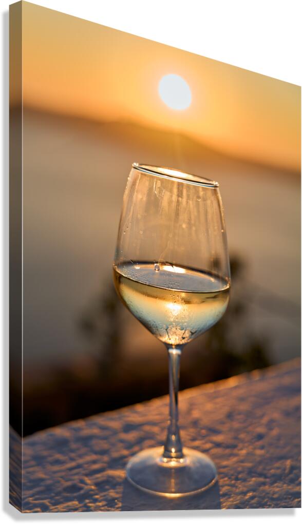 Wine glass reflecting golden sunset over water.