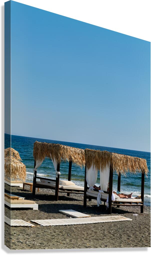 Person relaxing in a beach cabana by the sea.