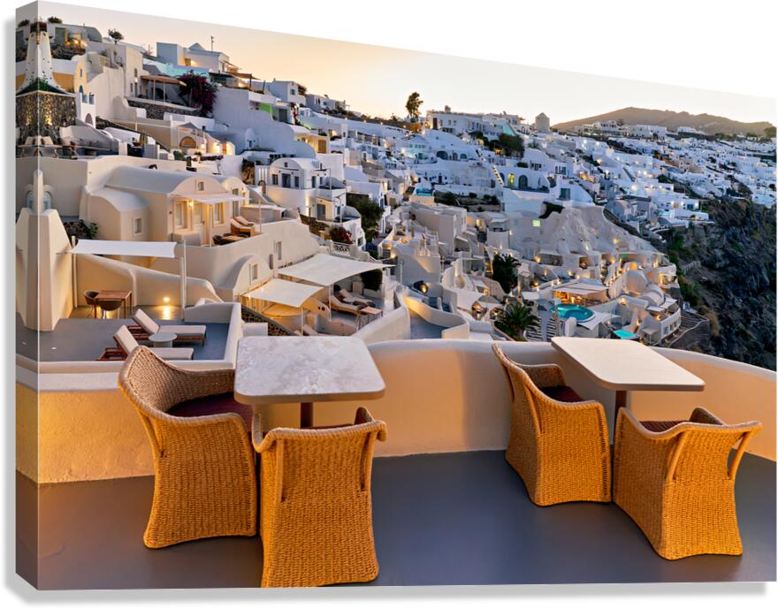Santorini village at dusk illuminated with outdoor dining terr