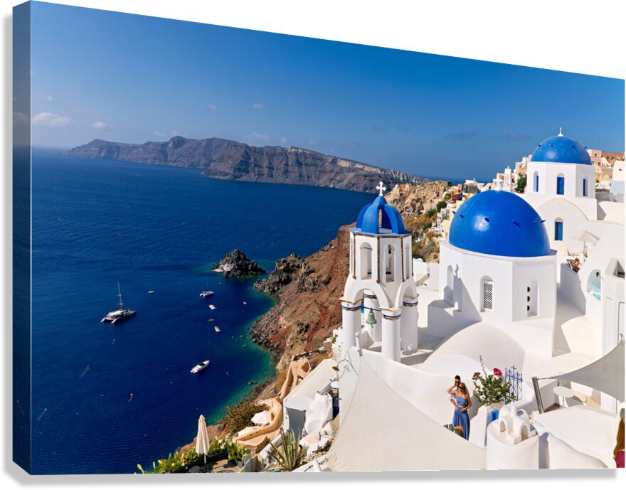 Picturesque Santorini: blue domes white buildings and caldera 