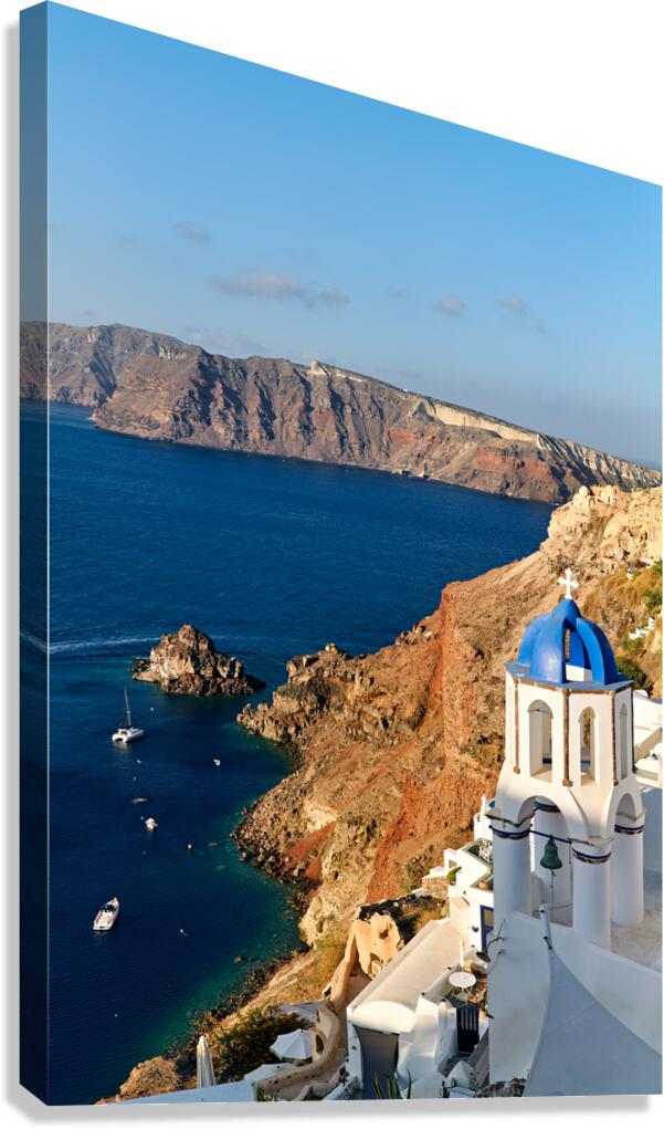 Santorinis iconic blue domed church overlooks the caldera and v