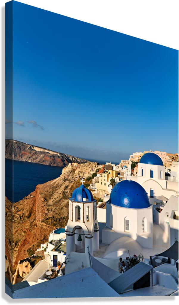 Iconic blue domed churches and white buildings in Santorini Gre