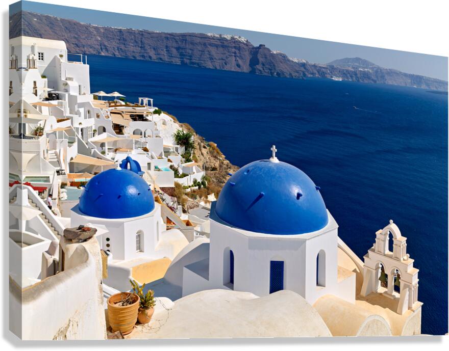 Beautiful Santorini: White buildings blue domes and deep blue 