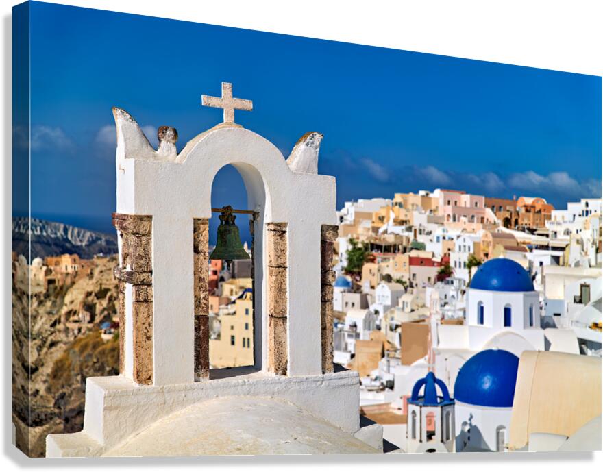 Santorinis iconic bell tower white houses blue domes caldera