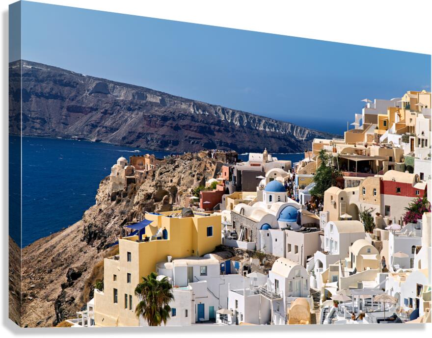 Picturesque Santorini village on cliff overlooking Aegean Sea.